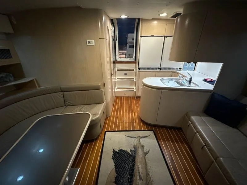 Slide: The Image of Interior of 1996 Tiara Yachts 43 Open with modern kitchen and seating area. - 16