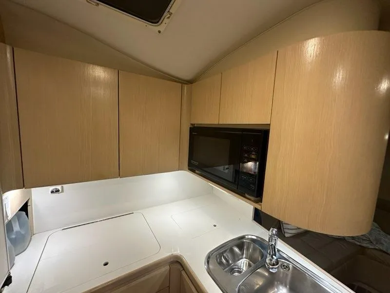 Slide: The Image of 1996 Tiara Yachts 43 Open kitchen with wood cabinets and stainless steel sink. - 20