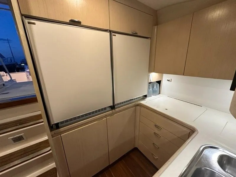 Slide: The Image of 1996 Tiara Yachts 43 Open kitchen with dual fridges and ample storage. - 22