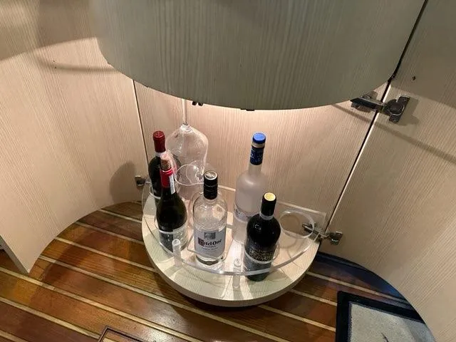 Slide: The Image of Liquor cabinet on 1996 Tiara Yachts 43 Open with assorted bottles and glasses. - 23