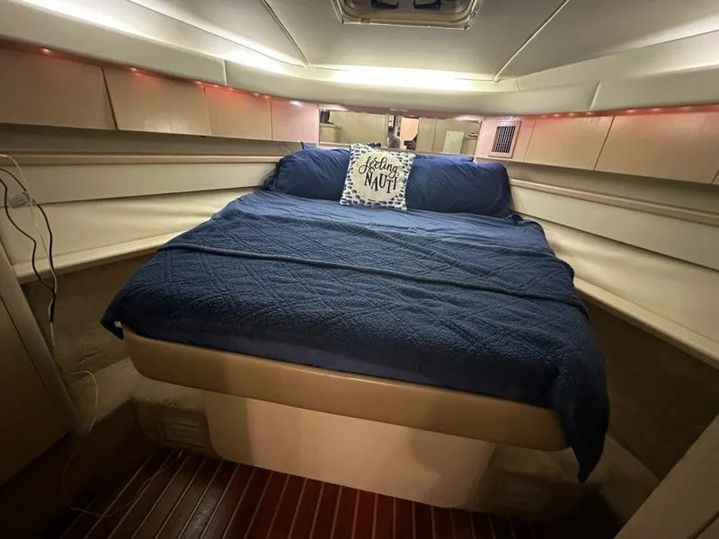 Slide: The Image of Cozy cabin interior of 1996 Tiara Yachts 43 Open with blue bedding. - 24