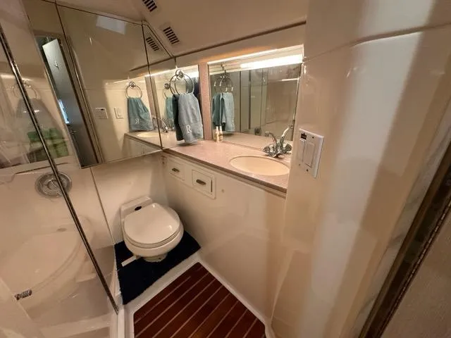 Slide: The Image of Bathroom interior of 1996 Tiara Yachts 43 Open, featuring modern fixtures and wood flooring. - 29
