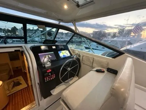 Slide: The Image of 1996 Tiara Yachts 43 Open helm with modern navigation, marina view at sunset. - 32
