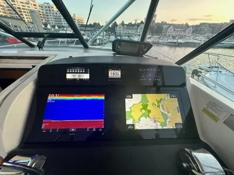 Slide: The Image of Tiara Yachts 1996 43 Open dashboard with navigation screens and marina view. - 4