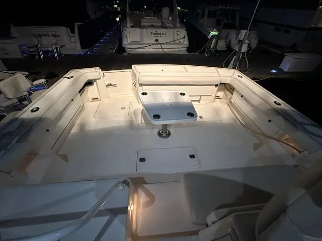 Slide: The Image of 1996 Tiara Yachts 43 Open boat deck with seating and table, illuminated at night. - 49