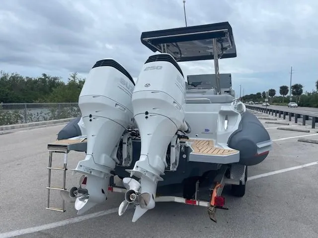 Slide: The Image of 2023 Zar Formenti 85 SL boat with dual outboard motors on a trailer. - 4