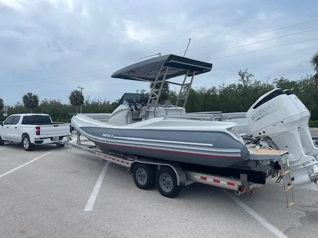 Slide: The Image of 2023 Zar Formenti 85 SL boat on trailer, parked in lot, attached to white truck. - 5