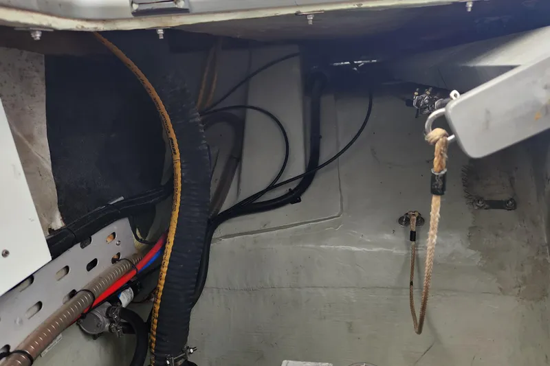 Slide: The Image of Engine compartment of a 2015 Leopard 44 boat, showing cables and hoses. - 101
