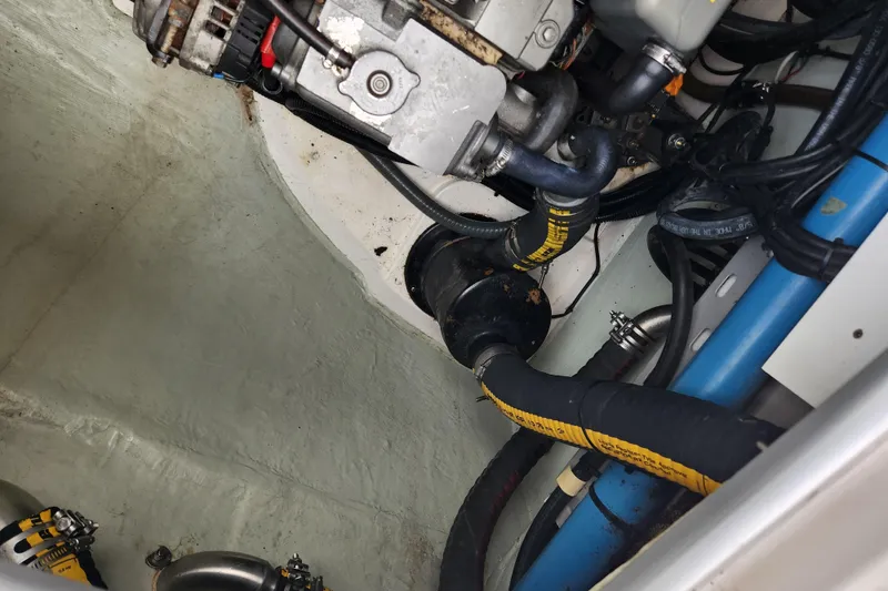 Slide: The Image of Engine compartment of a 2015 Leopard 44 boat with visible hoses and components. - 104