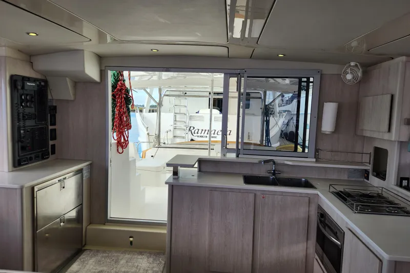 Slide: The Image of Interior of 2015 Leopard 44 yacht kitchen with modern appliances and outdoor view. - 112