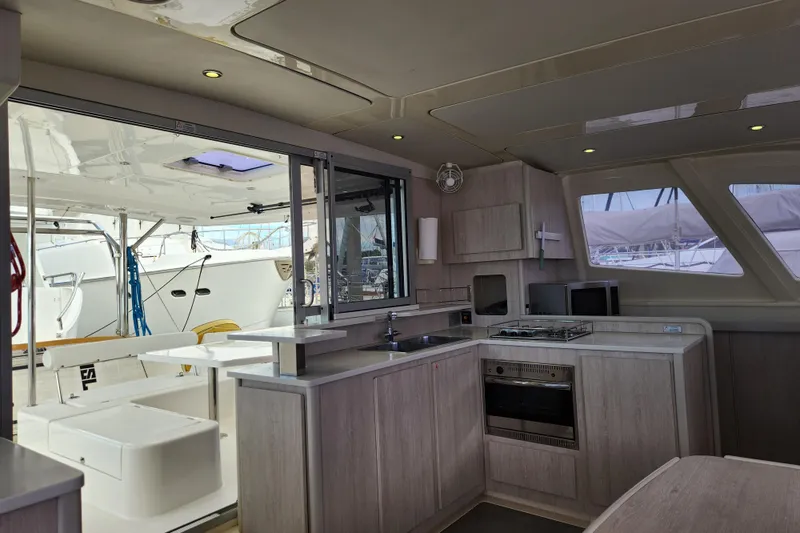 Slide: The Image of Modern kitchen interior on a 2015 Leopard 44 catamaran yacht, featuring sleek cabinetry and appliances. - 113