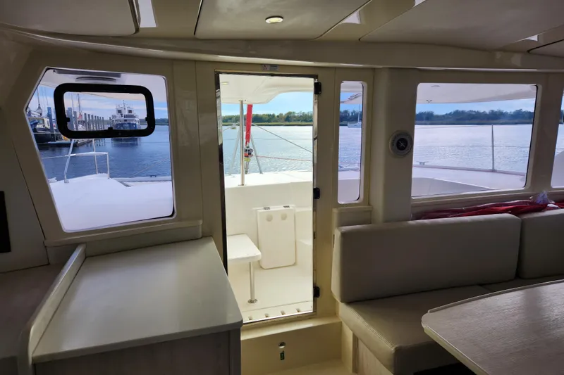 Slide: The Image of Interior view of 2015 Leopard 44 catamaran with water and dock visible through windows. - 131