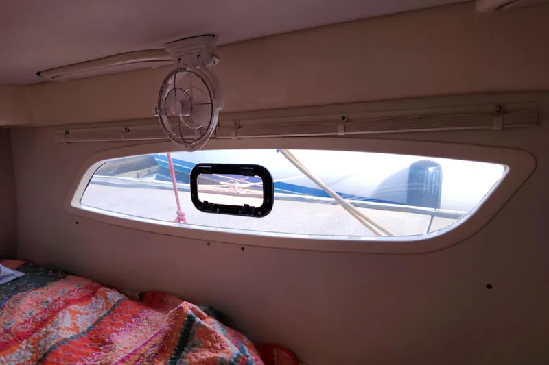 Slide: The Image of Interior view of a 2015 Leopard 44 yacht cabin with window and colorful bedding. - 141