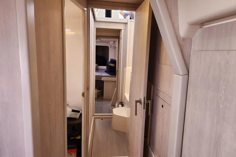 Slide: The Image of Interior view of 2015 Leopard 44 yacht, featuring a narrow hallway and cabin. - 142