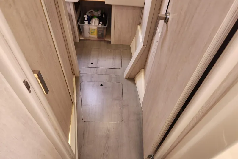 Slide: The Image of Interior of a 2015 Leopard 44 yacht with storage compartments and cleaning supplies. - 143