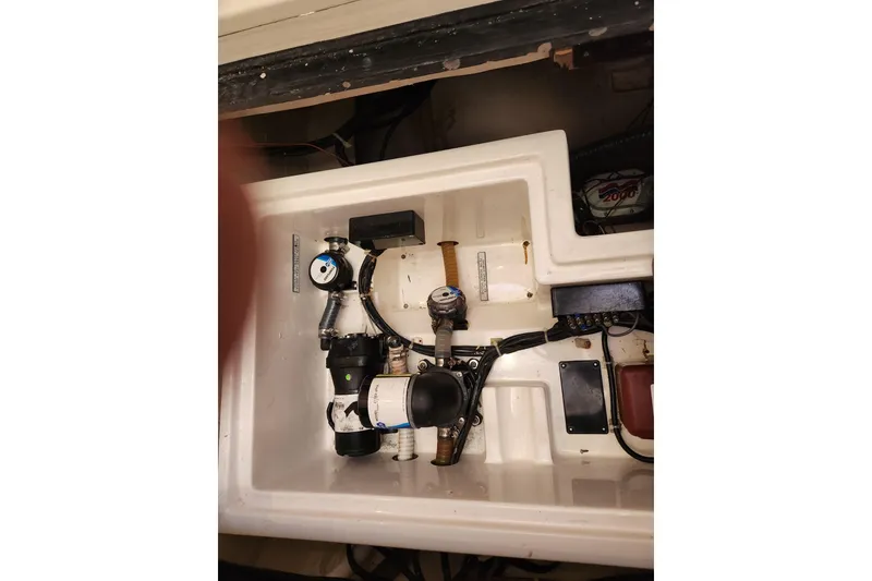 Slide: The Image of Engine compartment of a 2015 Leopard 44 boat, showcasing mechanical components and wiring. - 145