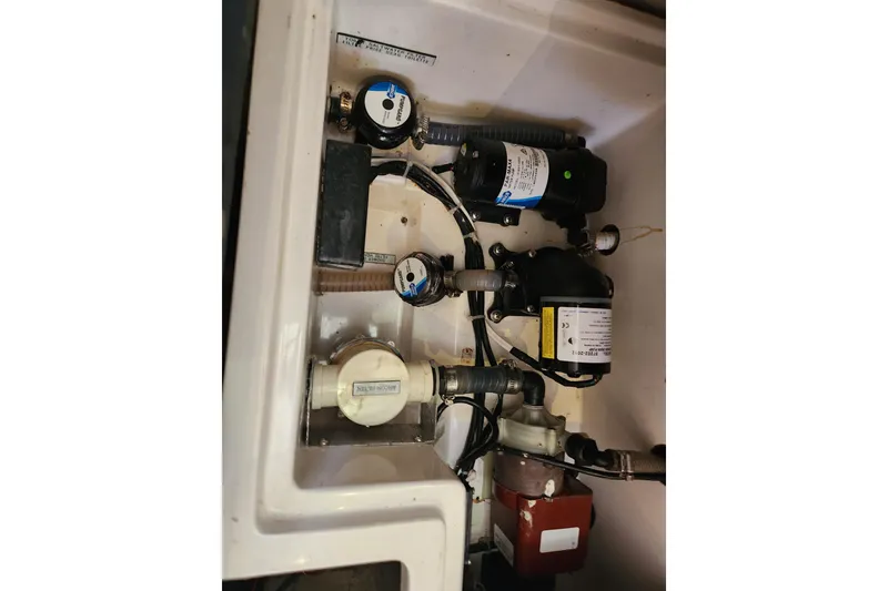 Slide: The Image of Engine compartment of a 2015 Leopard 44, showcasing various mechanical components and wiring. - 146