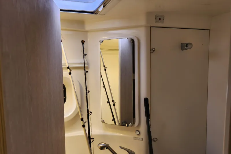Slide: The Image of Interior of 2015 Leopard 44 boat bathroom with fishing rods and mirror. - 148