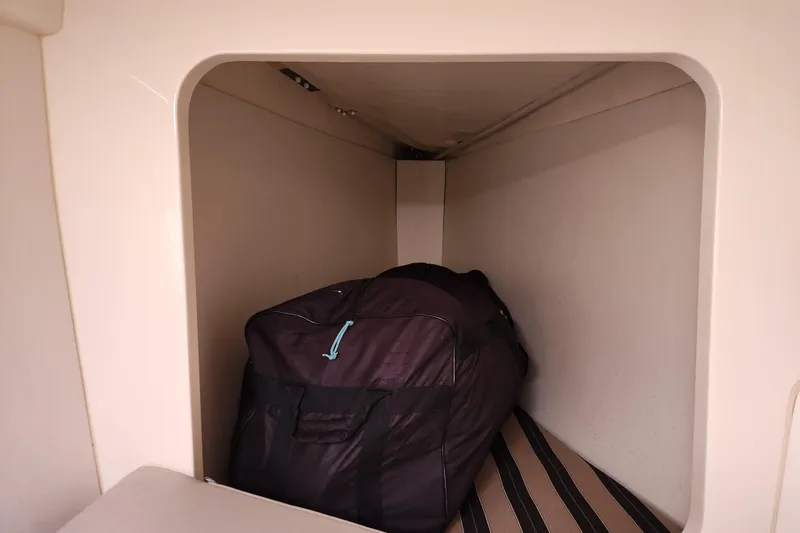 Slide: The Image of Storage compartment in a 2015 Leopard 44 yacht with a large black bag. - 152