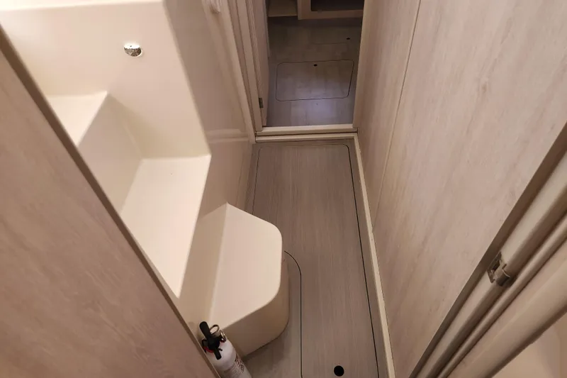 Slide: The Image of Narrow hallway in a 2015 Leopard 44 yacht with a fire extinguisher. - 159