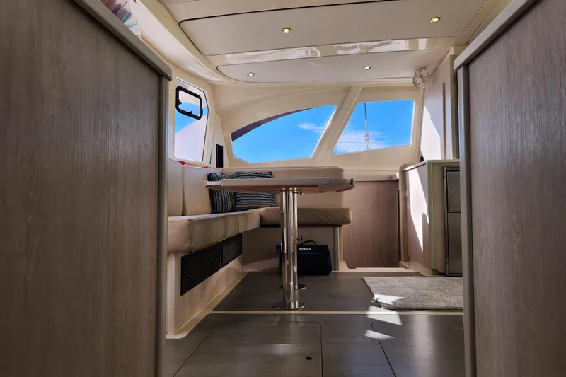 Slide: The Image of Interior of 2015 Leopard 44 catamaran with modern seating and panoramic windows. - 160