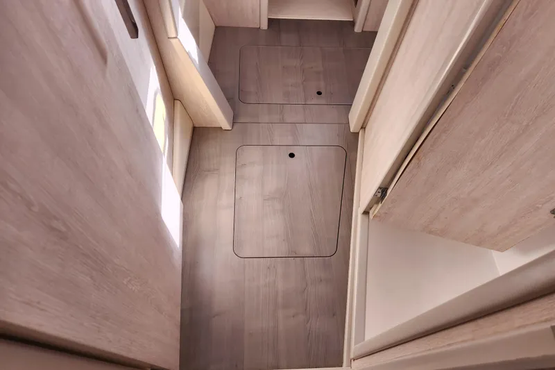 Slide: The Image of Interior view of 2015 Leopard 44 yacht with wooden flooring and storage compartments. - 163