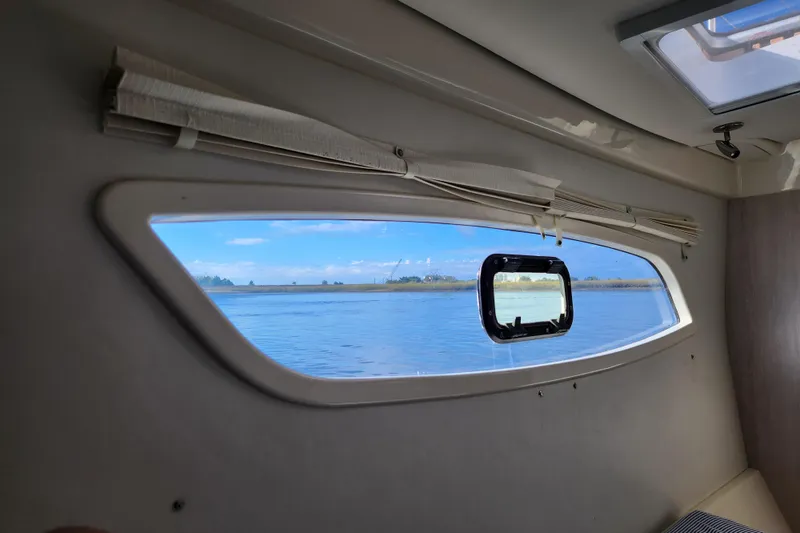 Slide: The Image of Interior view from a 2015 Leopard 44 yacht, showcasing a scenic waterway through the window. - 167
