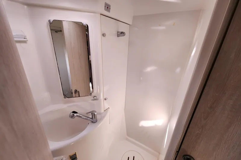 Slide: The Image of Compact bathroom in a 2015 Leopard 44 yacht, featuring a sink and mirror. - 170