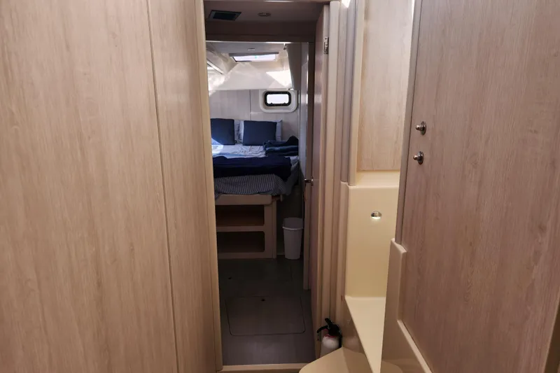 Slide: The Image of Interior of 2015 Leopard 44 yacht, featuring a cozy cabin with wooden finishes. - 178