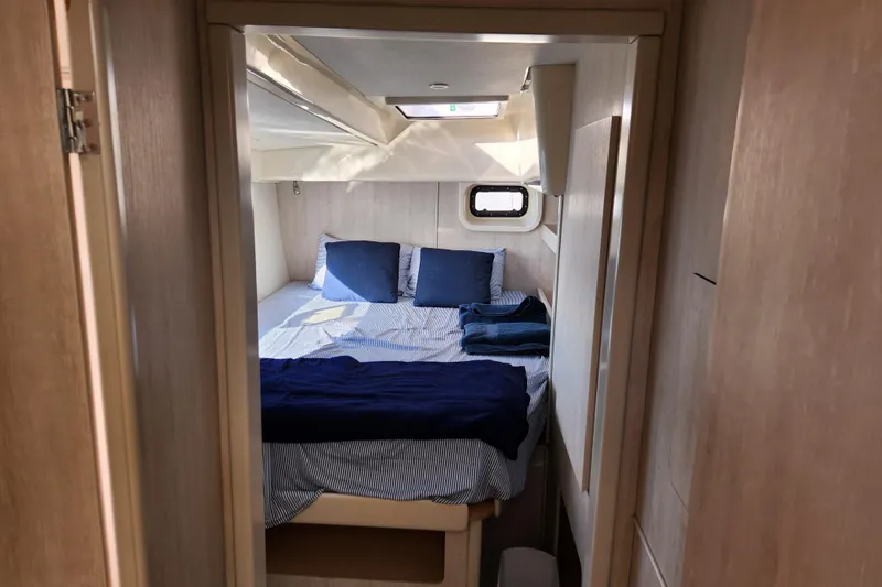 Slide: The Image of Cozy bedroom in 2015 Leopard 44 yacht with blue bedding and natural light. - 179
