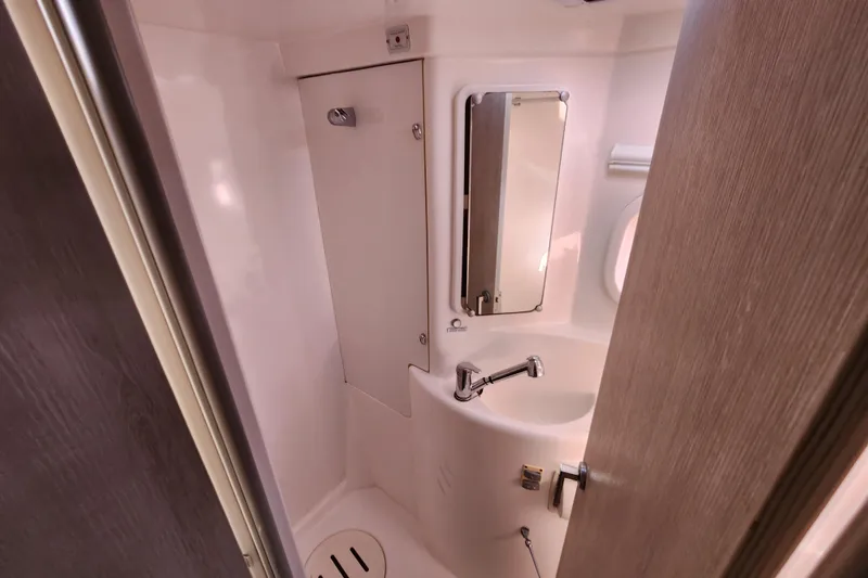 Slide: The Image of Compact bathroom in a 2015 Leopard 44 yacht, featuring a sink and mirror. - 184