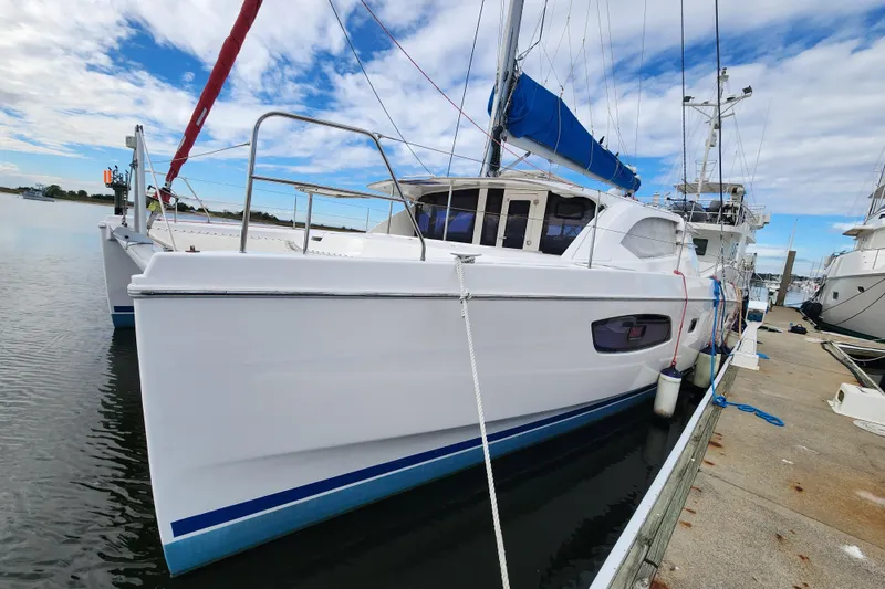 Slide: The Image of 2015 Leopard 44 catamaran docked at marina under blue sky. - 2
