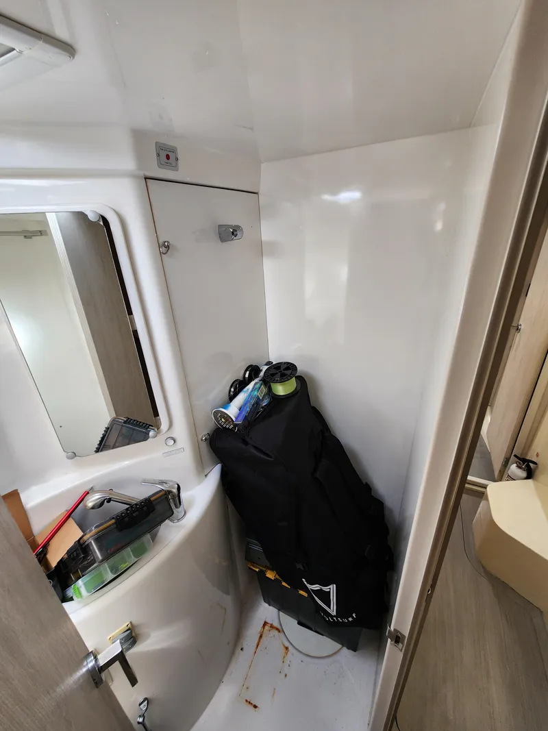 Slide: The Image of Leopard 44 catamaran helm with steering wheel and ropes, docked by calm waters. - 25