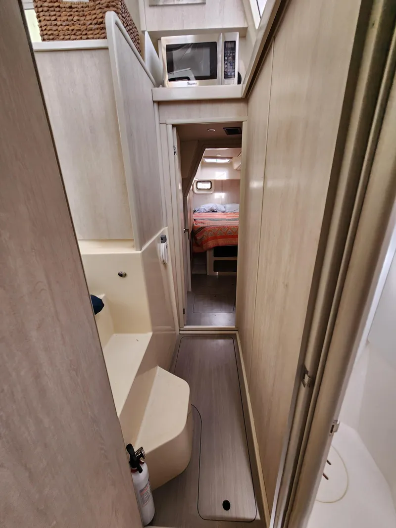 Slide: The Image of 2015 Leopard 44 catamaran interior with docked boats in marina background. - 28