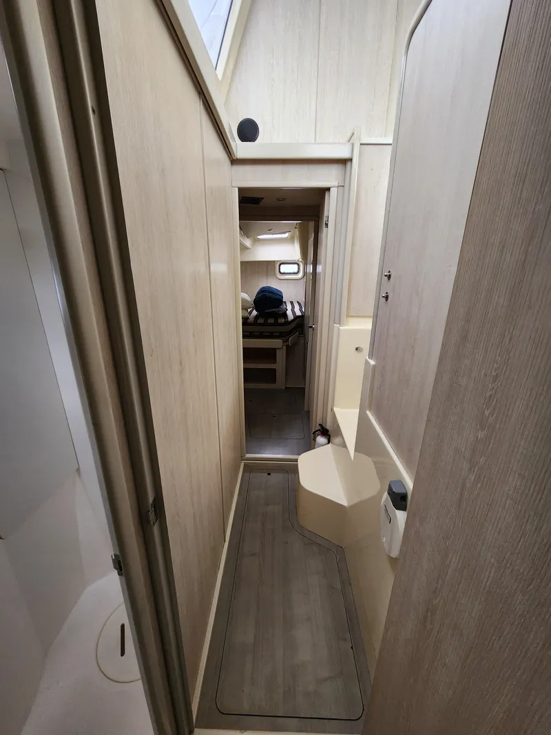 Slide: The Image of Leopard 44 catamaran interior with surfboard, docked on calm water, 2015 model. - 29