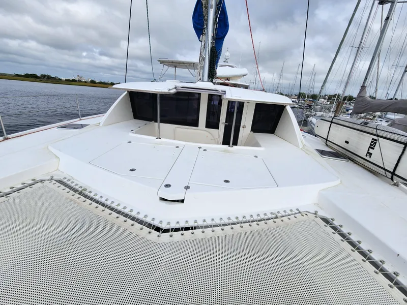 Slide: The Image of Cockpit view of a 2015 Leopard 44 catamaran docked at a marina. - 32