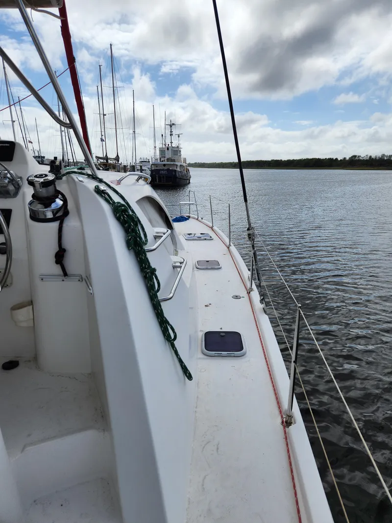 Slide: The Image of 2015 Leopard 44 catamaran helm station with canopy, docked under cloudy skies. - 42