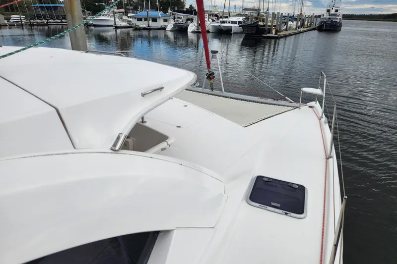 Slide: The Image of 2015 Leopard 44 catamaran docked at marina, showcasing sleek design and spacious deck. - 51