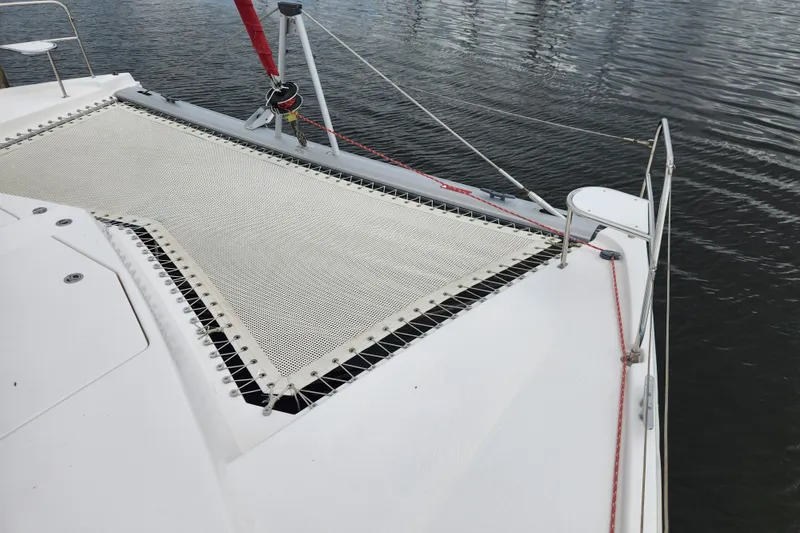 Slide: The Image of 2015 Leopard 44 catamaran deck with netting over calm water. - 52