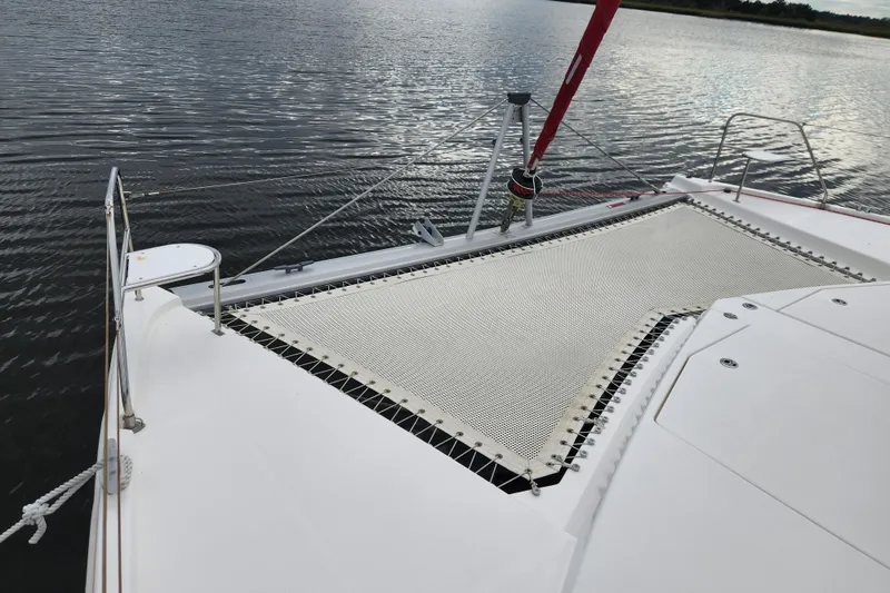 Slide: The Image of 2015 Leopard 44 catamaran with netting on deck, anchored on calm water. - 54