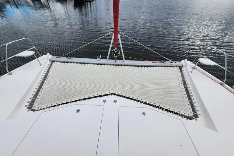 Slide: The Image of Front deck of a 2015 Leopard 44 catamaran with netting over calm water. - 55