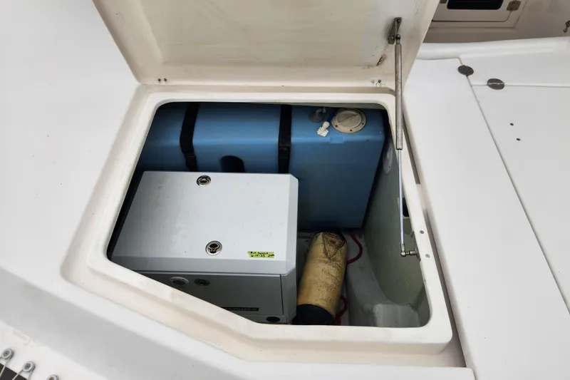 Slide: The Image of Open storage compartment on 2015 Leopard 44 boat, showing equipment and blue tank. - 63