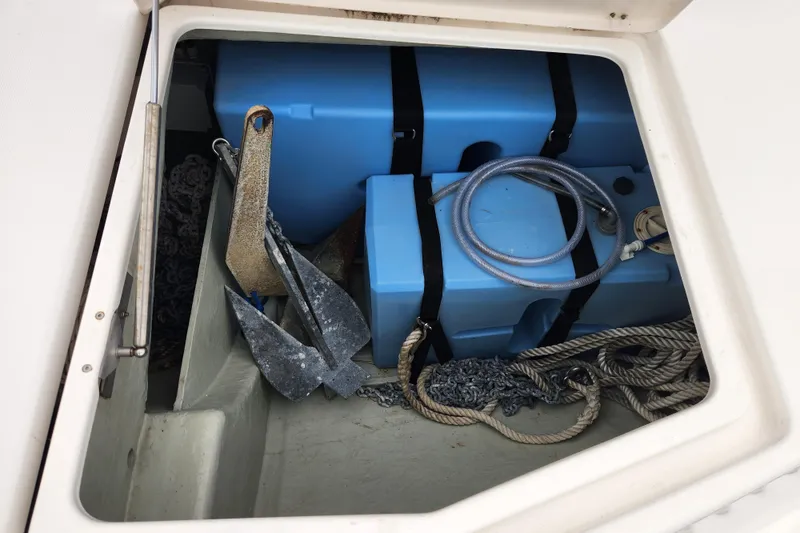 Slide: The Image of Storage compartment on a 2015 Leopard 44 boat with anchor, ropes, and blue containers. - 66