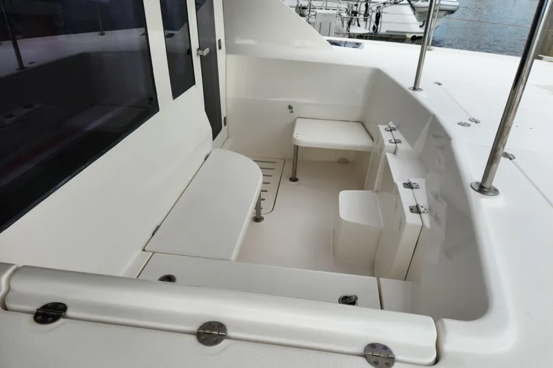 Slide: The Image of 2015 Leopard 44 yacht cockpit with seating and table, featuring sleek white design. - 72