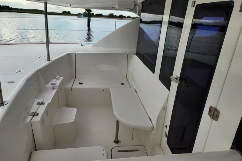 Slide: The Image of 2015 Leopard 44 yacht cockpit with seating, overlooking calm waters. - 73