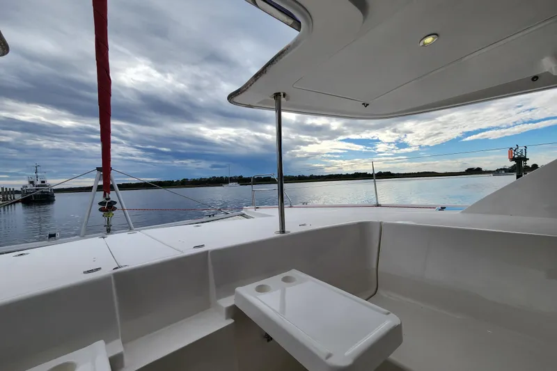 Slide: The Image of 2015 Leopard 44 catamaran deck view with serene waters and cloudy sky. - 77