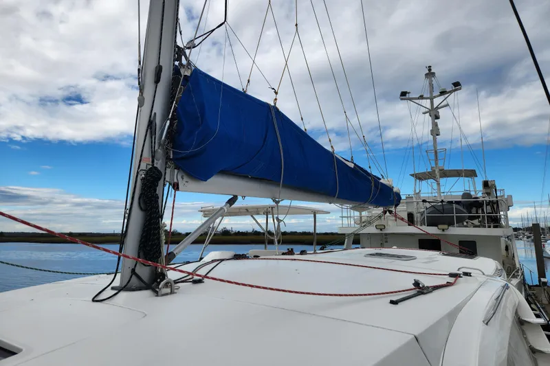 Slide: The Image of 2015 Leopard 44 catamaran with blue sail cover docked under cloudy sky. - 79