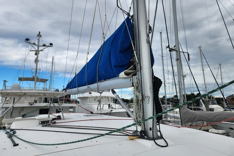 Slide: The Image of Sailboat deck view of 2015 Leopard 44 with blue sail cover in marina. - 80