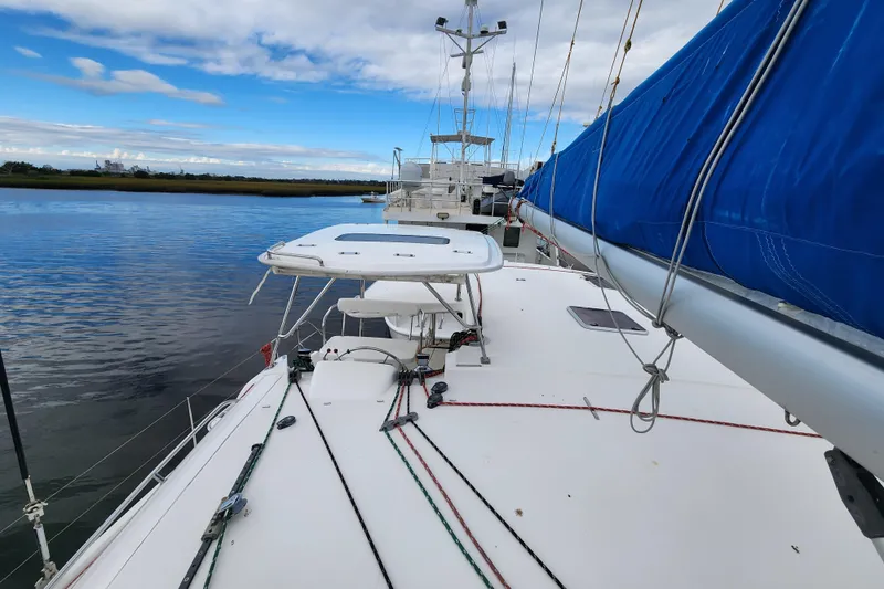 Slide: The Image of Sailing catamaran Leopard 44, 2015 model, docked with blue sail cover, calm waters. - 81