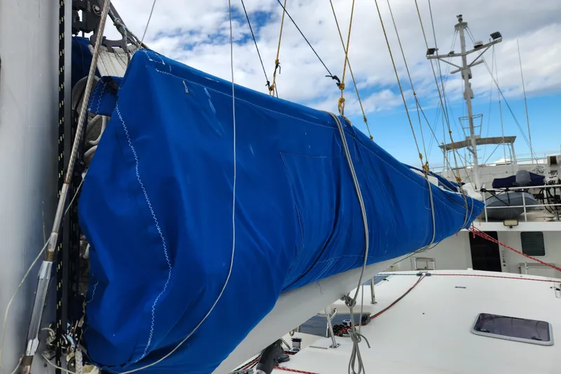 Slide: The Image of 2015 Leopard 44 sailboat with blue sail cover on deck. - 84
